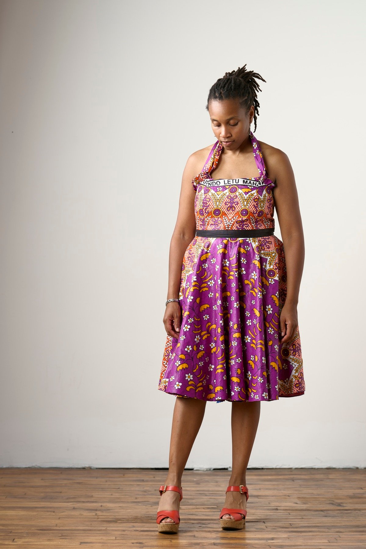 Rachel looking down in a colorful dress